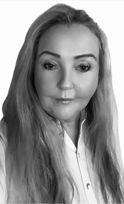 Black and white portrait of a woman with long hair and a white shirt.