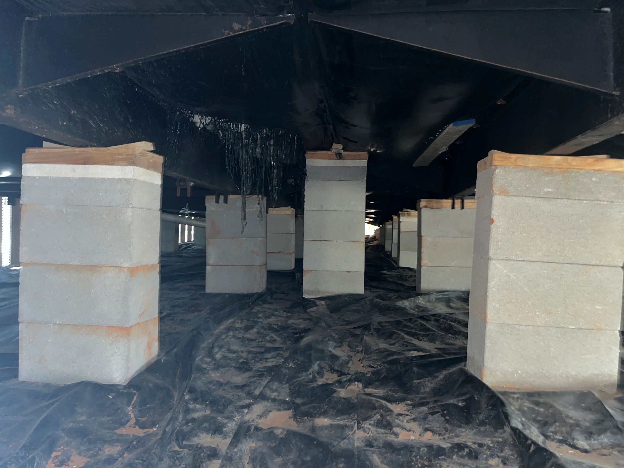 Concrete block piers supporting the steel chassis of a manufactured home