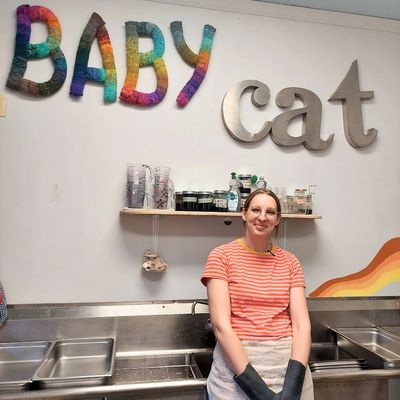 Woman standing in Baby Cat Yarns dye studio.