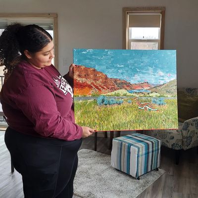 Wyoming artist Tatiana Thompson shows off a new painting she made while at Kestrel Fields Studio.