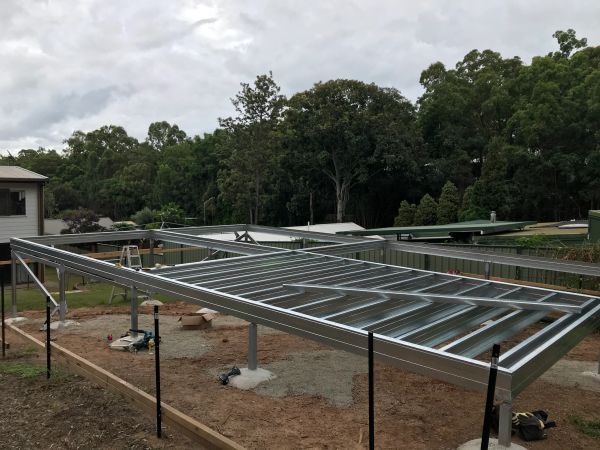 Metal framework for a building under construction on a cloudy day.