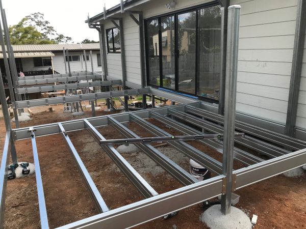 Metal framework foundation for a house extension under construction.