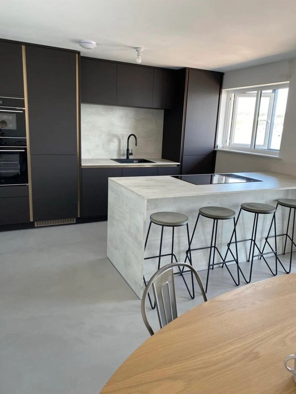 This kitchen has a microcement floor in the colour galet
