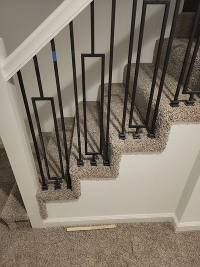 Tan stair with white wall and white rail installed by flooring It Kc 