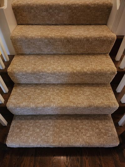 Carpeted stairs with beige patterned carpet. Installed in Leawood, Ks by Flooring It Kc