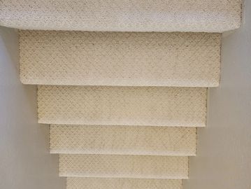 beige carpeted stairs with grey walls installed by Flooring it KC in Kansas City, MO