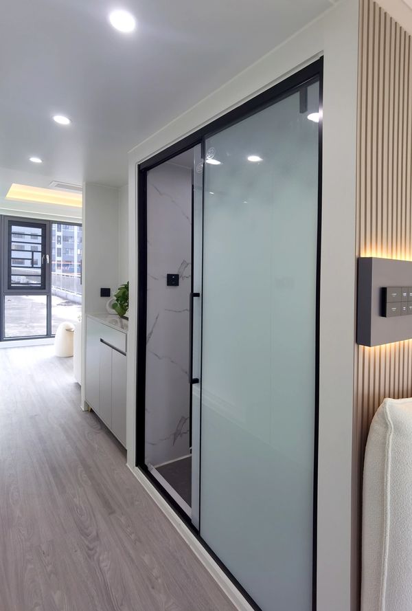 Modern interior with frosted glass door and sleek flooring.