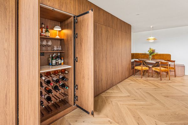 Hidden wooden wine cellar cabinet with dining area.