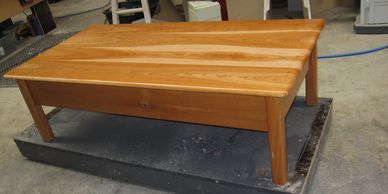 Wooden coffee table on a platform.