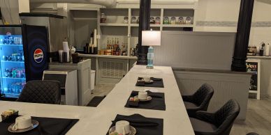 Cozy café counter with drinks and coffee setup.