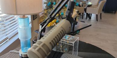 Microphone and piano with Christmas decorations in the background.