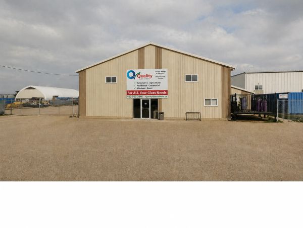 Building with a sign for Quality Glasswork and glass services.