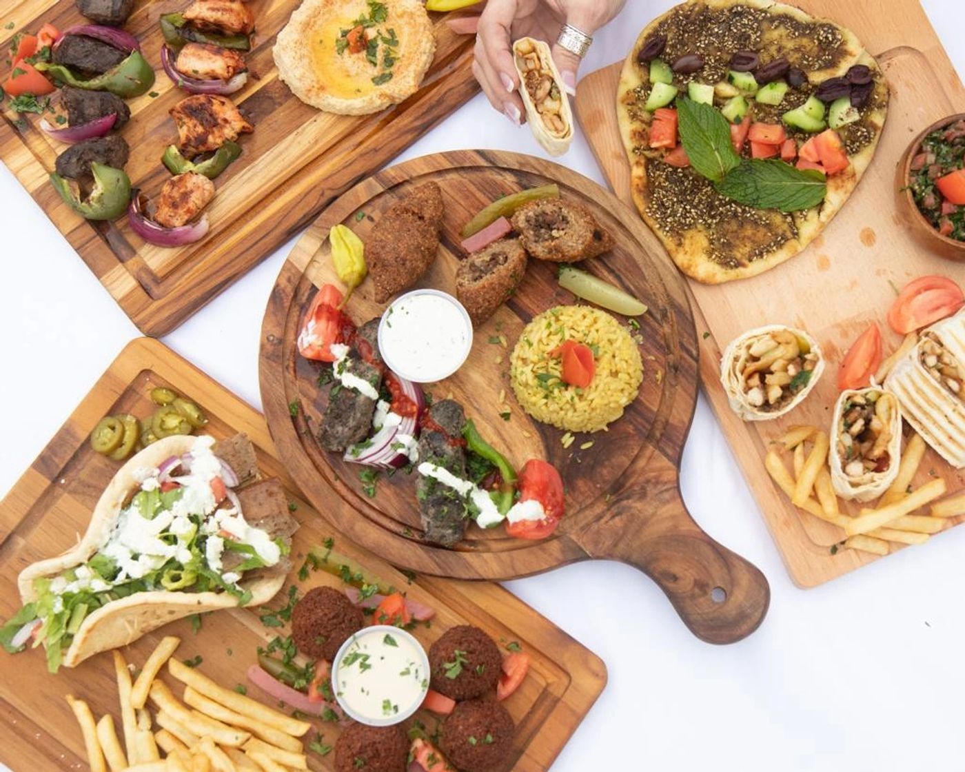 Wooden boards of mixed grill, manouche, falafel, wraps, hummus and tabbouleh
