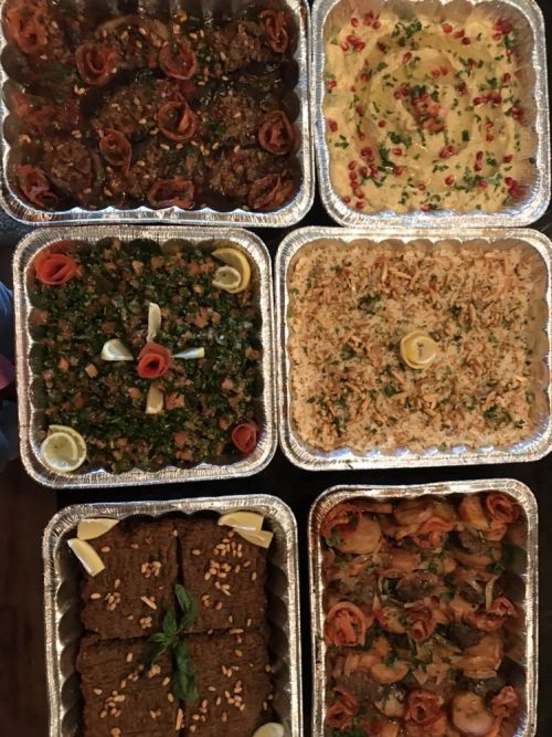 Catering trays of tabbouleh, rice and kibbeh