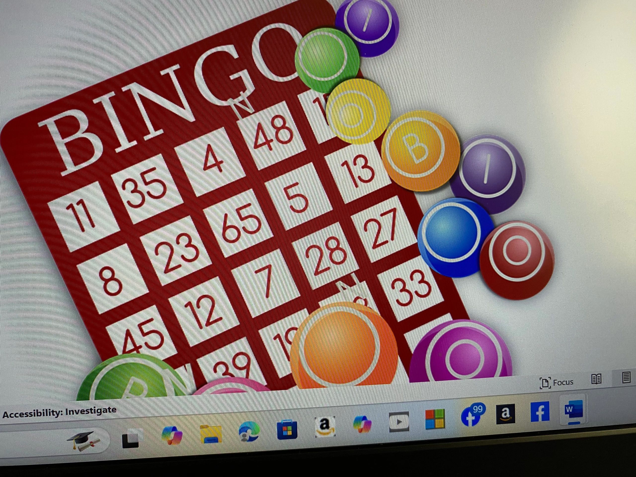 Colorful bingo balls on a computer screen with a bingo card.