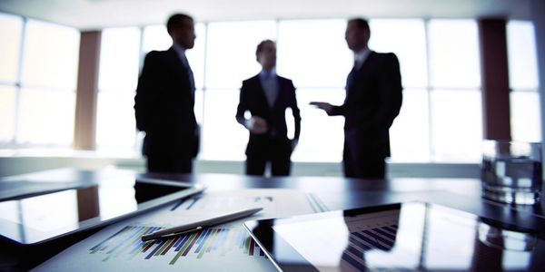 A picture of men talking about business in a conference room