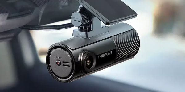 Close-up of a Thinkware dash camera mounted inside a vehicle.