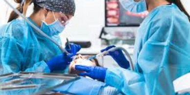 Dentists performing a dental procedure on a patient.