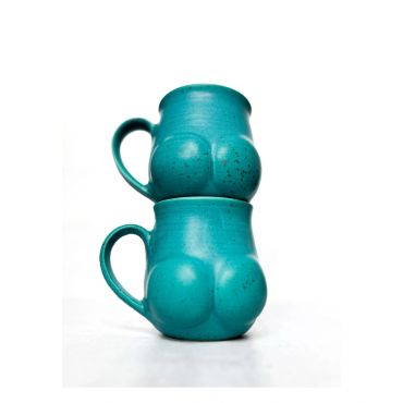 Two turquoise ceramic mugs shaped like buttocks stacked.