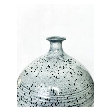 Speckled ceramic vase with a narrow neck.