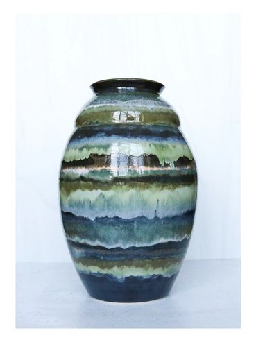 Striped ceramic vase with blue and green hues.