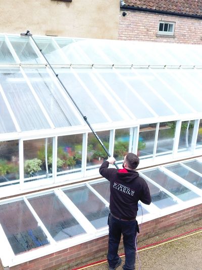 Window cleaner cleaning conservatory roof 