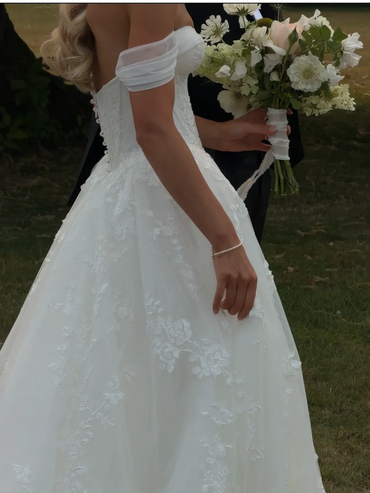 Bride in white wedding dress holding a bouquet.