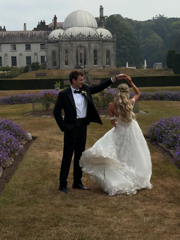 A couple dancing outdoors at a wedding.