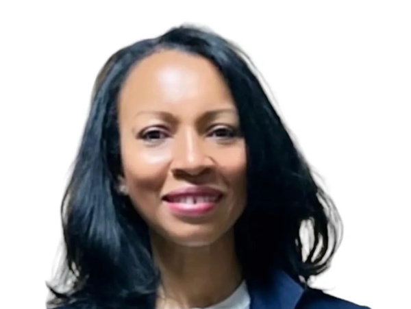 Portrait of a smiling woman with long black hair against a white background.