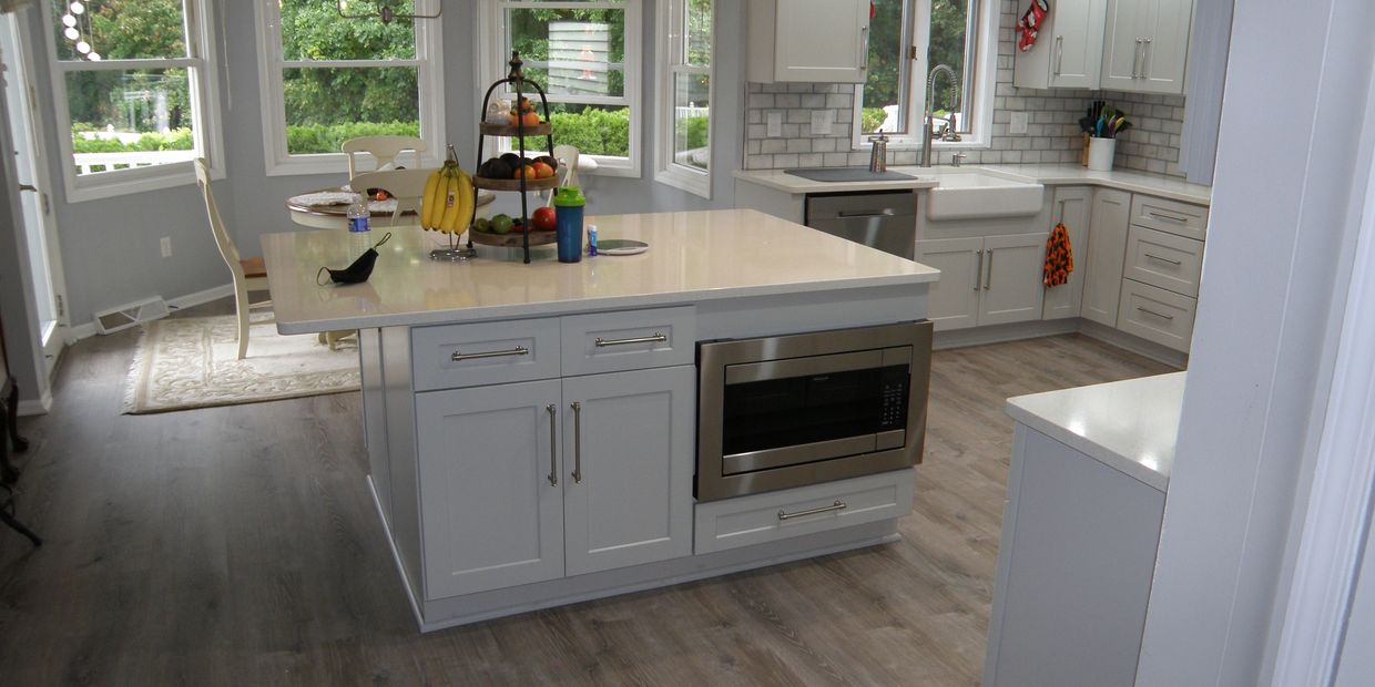 New cabinets, backsplash, large island with built in microwave, Farmers sink, LVT waterproof floor