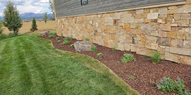 Professionally maintained landscape bed with mulch and plantings in Star Valley, Wyoming.