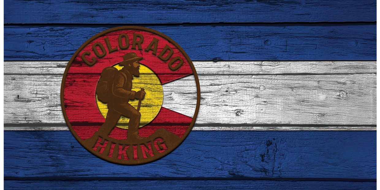 A wooden sign with the colorado hiking logo painted on it.