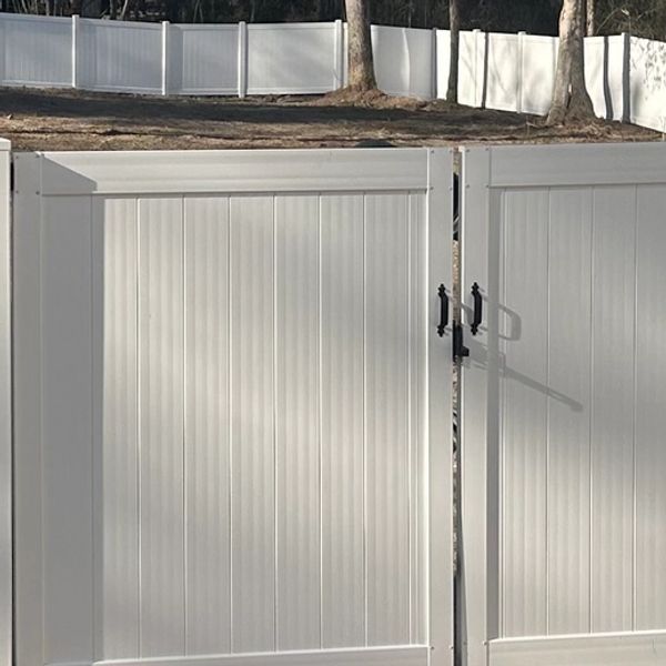 White vinyl fence and gate with black handles.