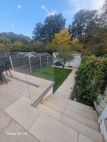 Raised patio with glass balustrades. Fine porcelain slabs. Excellenty landscaped in Twiclenham.