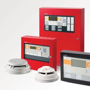 Red fire alarm control panels with smoke detectors.