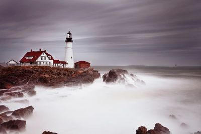 A lighthouse overlooking calm seas, representing how trauma therapy restores emotional calm.