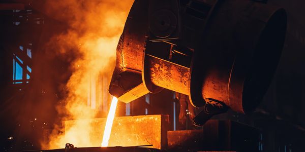 Hot steel pouring from a ladle.