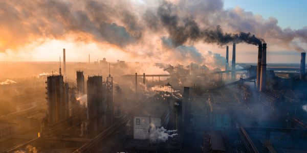 Smoky steel plant at dawn.