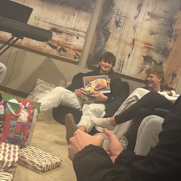 Friends enjoying a cozy gift exchange with laughter and smiles.