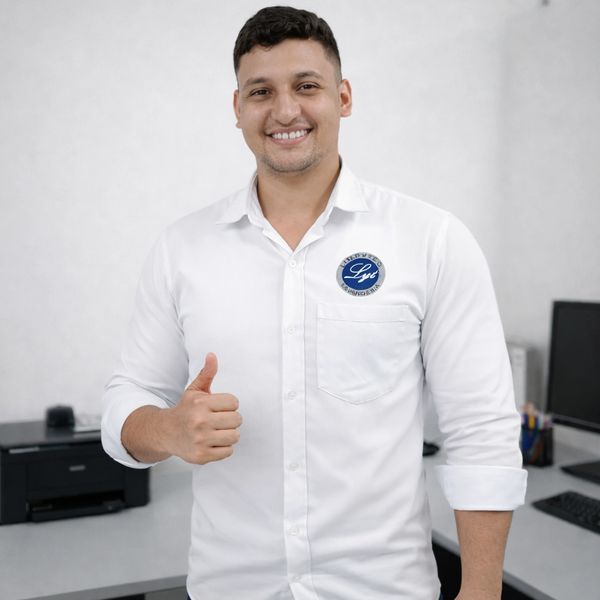 Man in white shirt giving a thumbs up in an office setting.