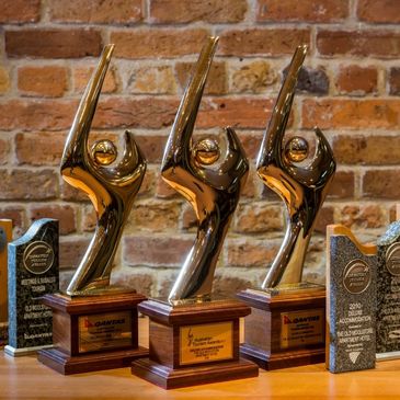 Gold trophies from the Australian Tourism Awards and Tasmanian Tourism Awards (authored by Kelly)