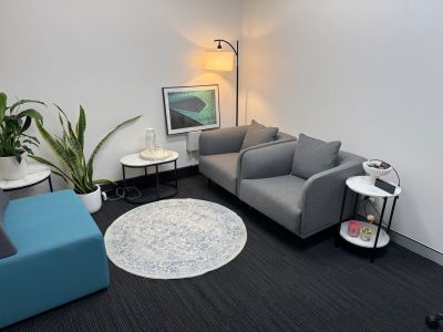 Modern lounge area with grey seating and a sleek floor lamp.