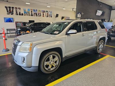 Silver SUV parked inside a showroom with Wilmington sign in the background.