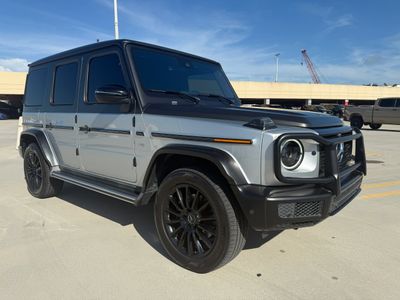 Silver luxury SUV parked outdoors with black rims and tinted windows.