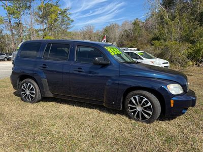 Dark blue SUV parked on grass with price displayed on windshield.