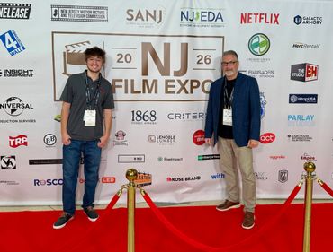 Two men posing on the red carpet at the NJ Film Expo 2026 event.