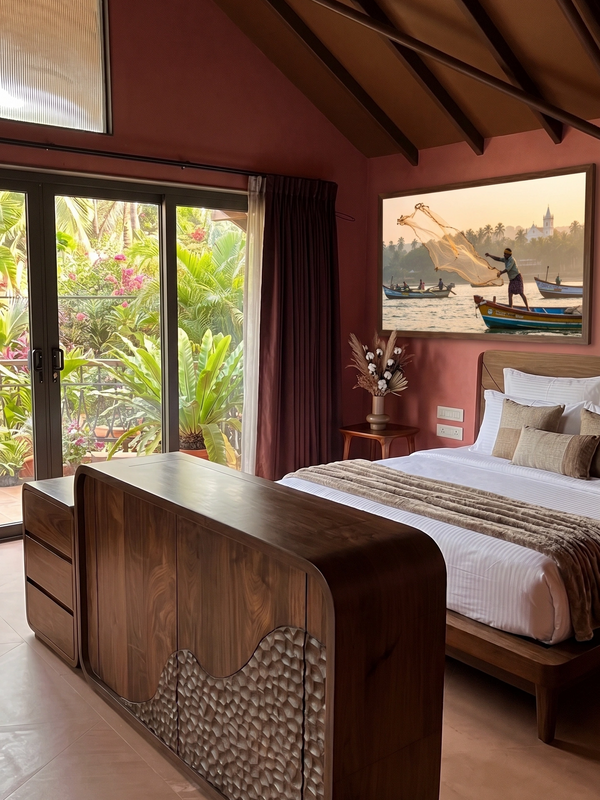 Cozy bedroom with modern wooden furniture and tropical balcony view.