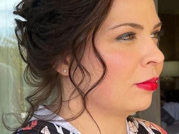 Profile of a woman with red lipstick and dark hair.