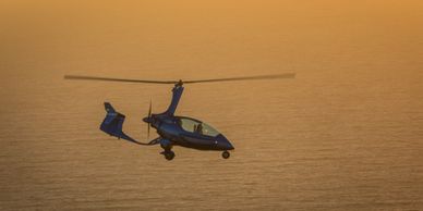 Gyroplane beach flight at sunset.