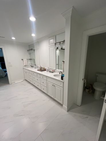 Vinings master bathroom after remodeling: full view of double vanity and new tile flooring
